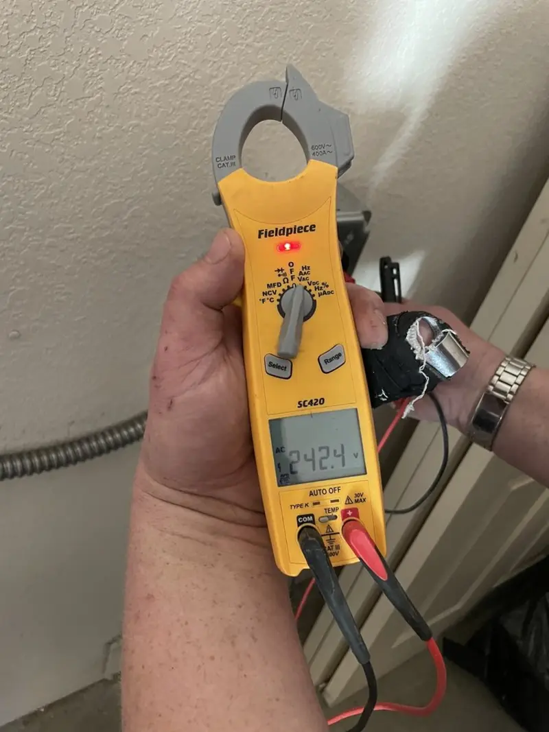 Voltage testing with clamp meter during Outlet Installation in Granville